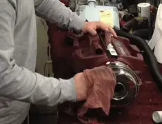 Vacuum repair technician cleaning and servicing a vacuum motor in Anchorage, AK
